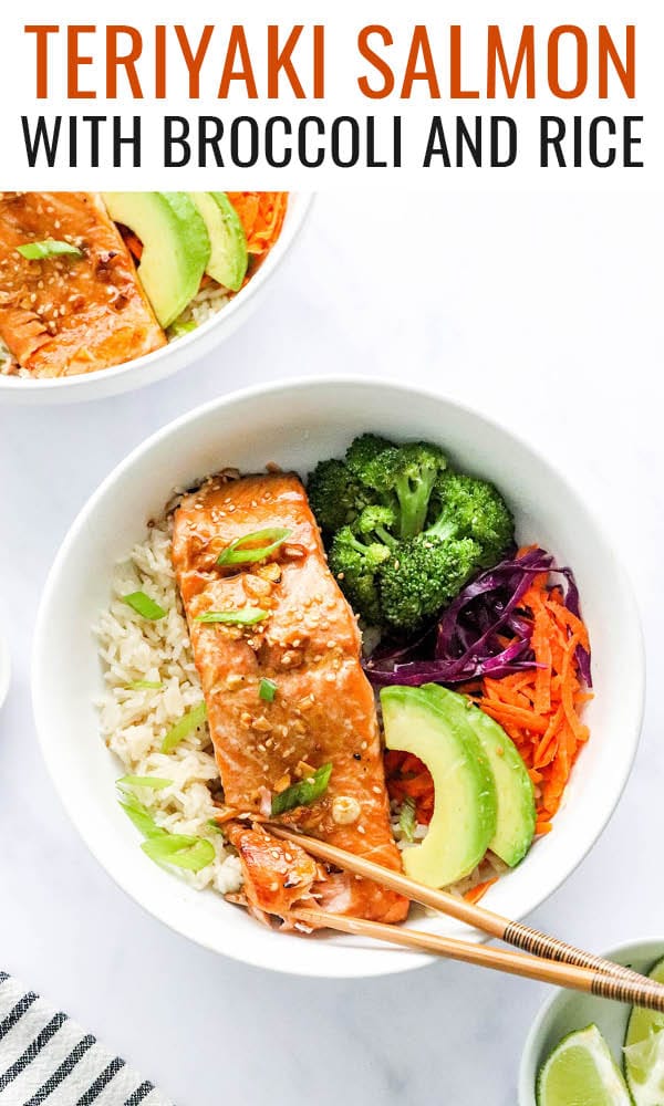 An overhead photo looking at a bowl of rice topped with a filet of teriyaki salmon, broccoli, shredded carrots, shredded cabbage, green onion and sliced avocado. There are two chopsticks resting on the bowl.