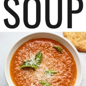 Bowl of tomato basil soup topped with basil and parmesan.