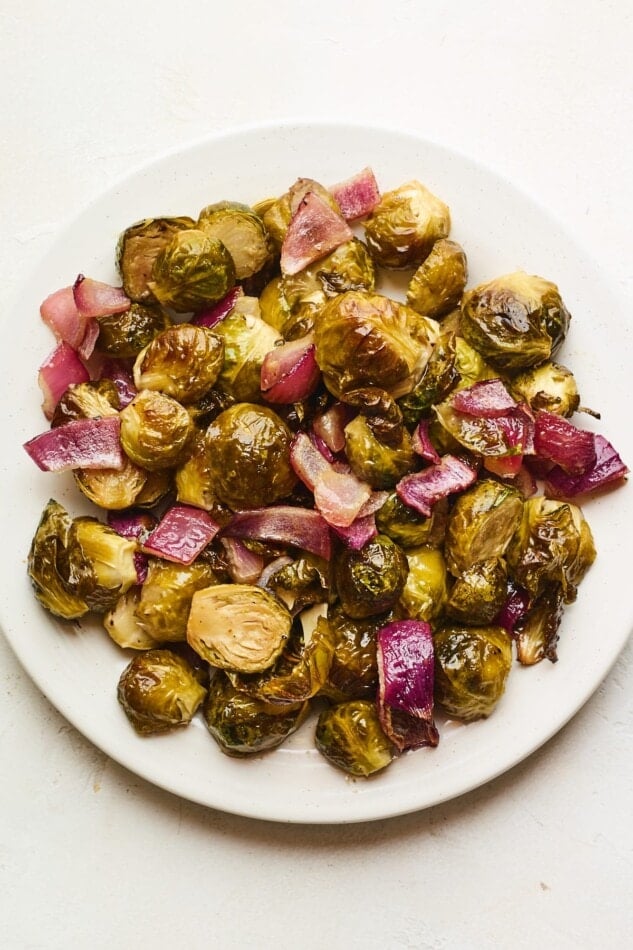 An overhead photo looking down on a plate of apple cider vinegar roasted Brussels sprouts.