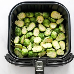 Brussels sprouts in the air fryer basket.