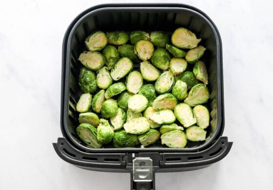 Brussels sprouts in the air fryer basket.