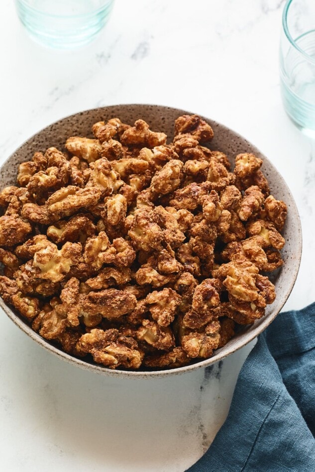 A serving bowl containing candied walnuts.