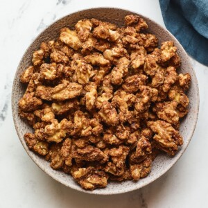 An overhead photo looking at a serving bowl containing candied walnuts.