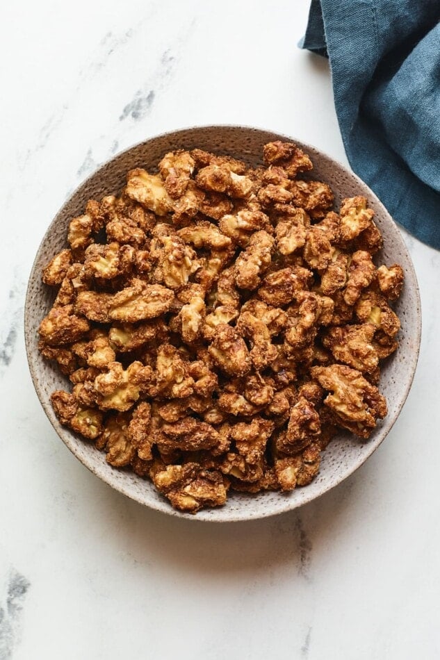 An overhead photo looking at a serving bowl containing candied walnuts.