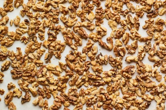 Walnuts spread across a sheet pan.