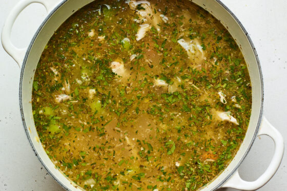 Chicken, parsley and lemon juice added to a dutch oven.