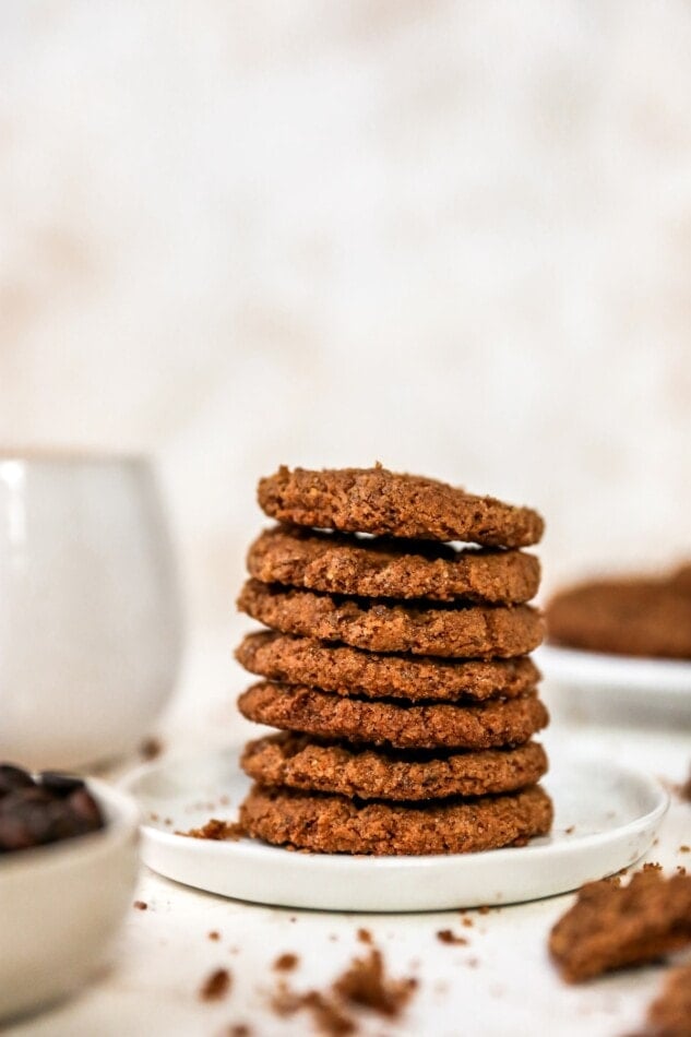 Crunchy and chewy, these almond butter espresso cookies are made with one bowl and only six ingredients. Plus, they're flourless, vegan and gluten-free! A stack of almond butter espresso cookies on a plate.