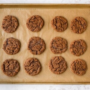 A sheet pan with freshly baked almond butter espresso cookies.