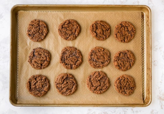 A sheet pan with freshly baked almond butter espresso cookies.