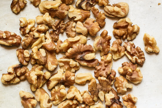 Chopped walnuts on a sheet pan.