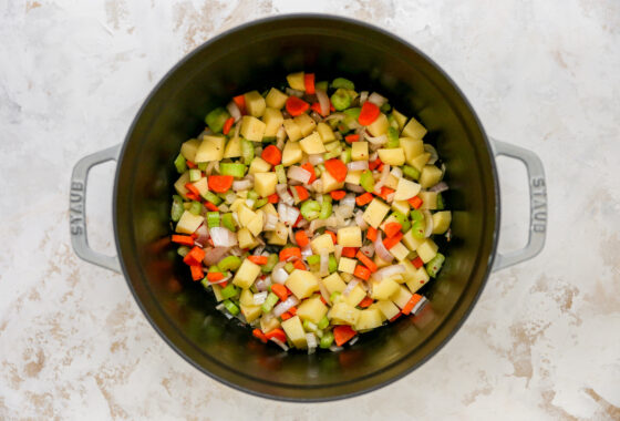 Chopped veggies for minestrone soup in a large pot.