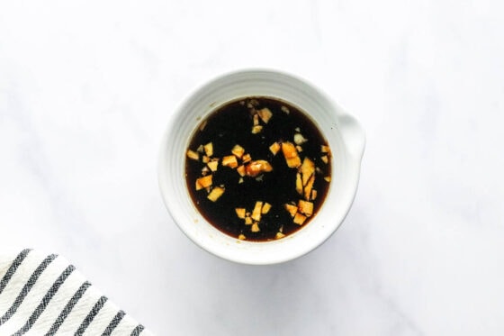 A mixing bowl containing teriyaki marinade.