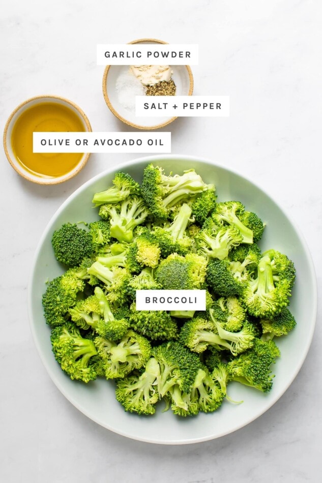 Ingredients measured out to make air fryer broccoli: garlic powder, salt, pepper, olive oil and broccoli.