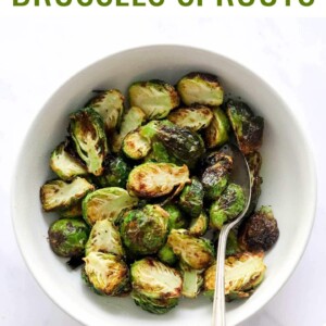 Serving bowl and spoon with crispy air fried brussels sprouts.