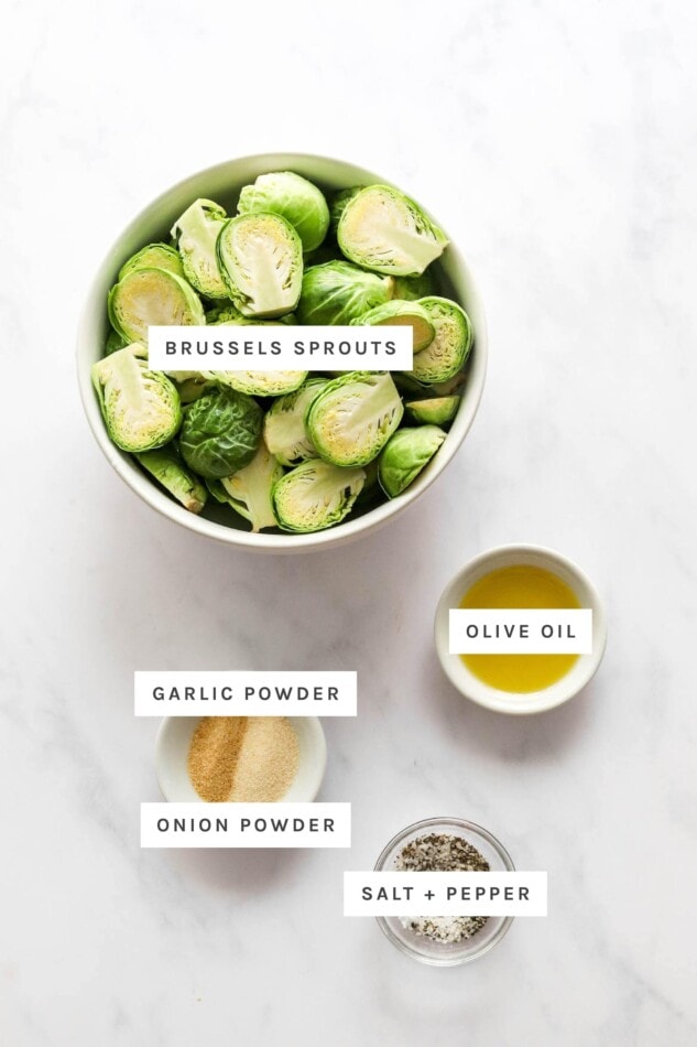 Ingredients measured out to make air fryer brussels sprouts: brussels, olive oil, garlic powder, onion powder, salt and pepper.