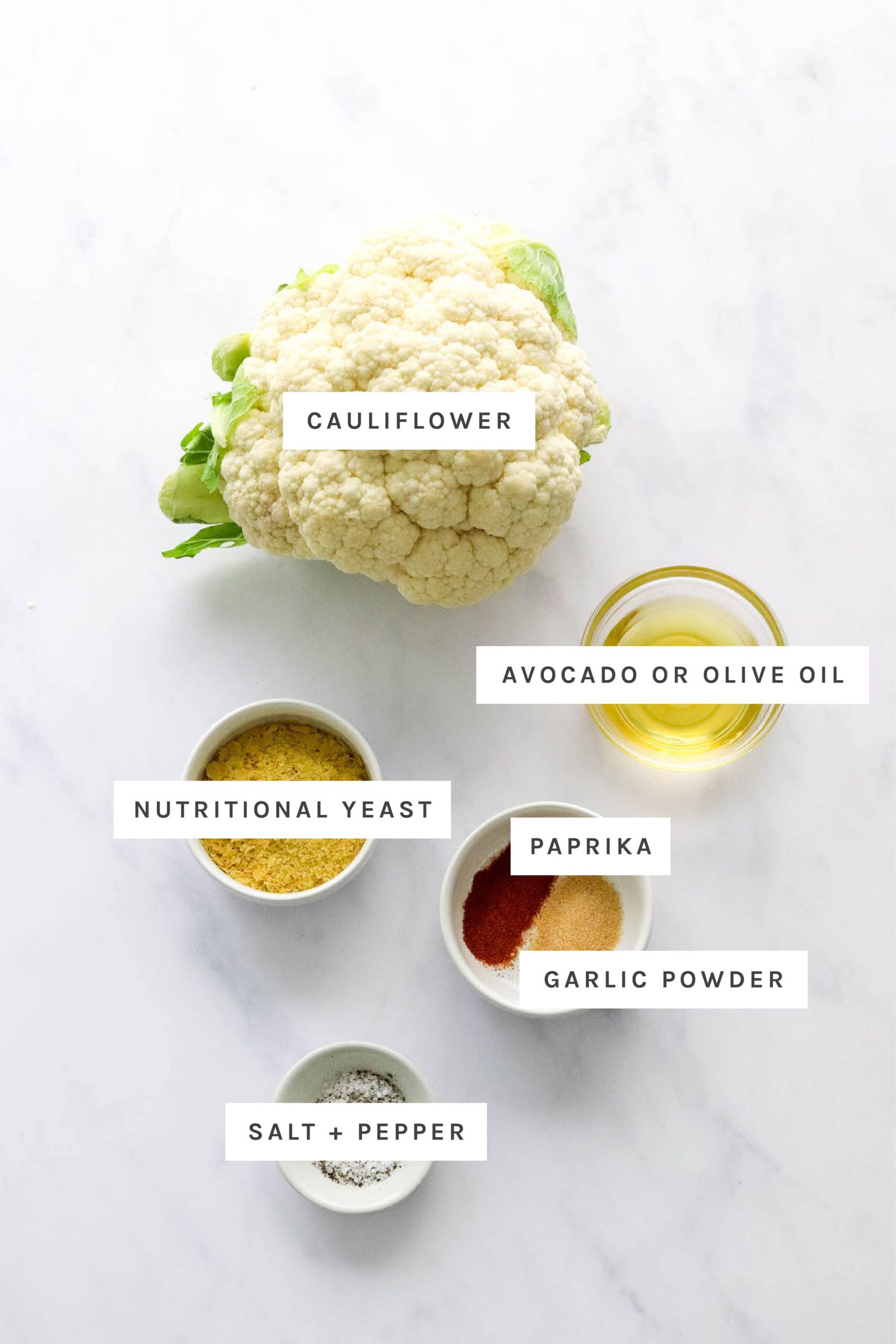 Ingredients measured out to make air fryer cauliflower: cauliflower, oil, nutritional yeast, paprika, garlic powder, salt and pepper.