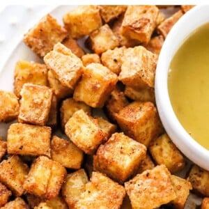 A close up photo of air fried tofu on a plate.