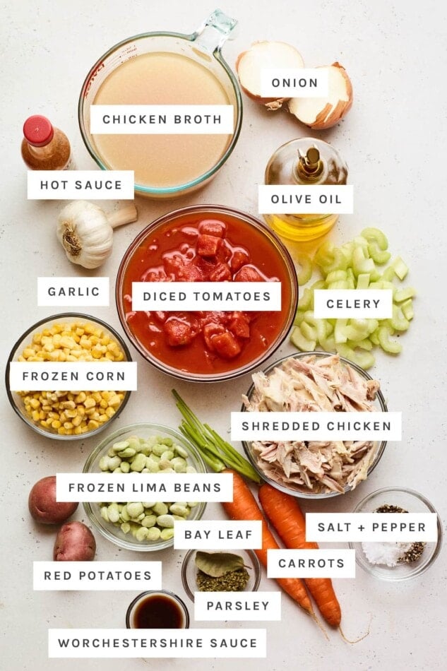 Ingredients measured out to make Brunswick stew: chicken broth, onion, hot sauce, olive oil, garlic, diced tomatoes, celery, frozen corn, shredded chicken, frozen lima beans, red potatoes, bay leaf, salt and pepper, carrots, parsley and Worcestershire sauce.