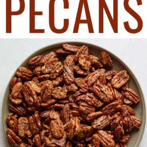 A shallow serving dish containing candied pecans.