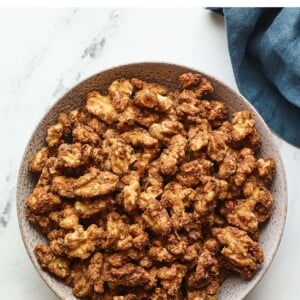 An overhead photo looking at a serving bowl containing candied walnuts.