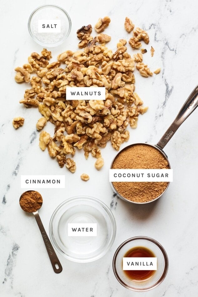 Ingredients measured out to make candied walnuts: salt, walnuts, coconut sugar, cinnamon, water, vanilla.