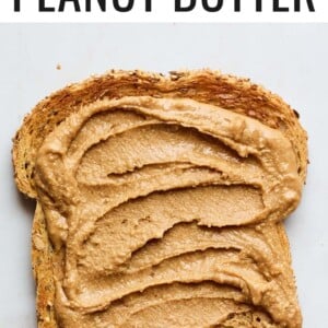 A slice of toast with cinnamon peanut butter spread on top.