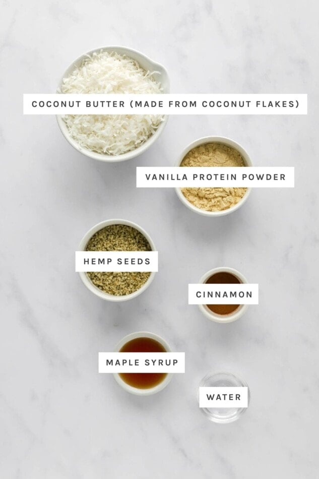 Ingredients measured out to make coconut protein balls: coconut, vanilla protein powder, hemp seeds, cinnamon, maple syrup and water.