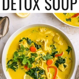 A bowl of detox soup topped with fresh cilantro. A spoon rests in the bowl.