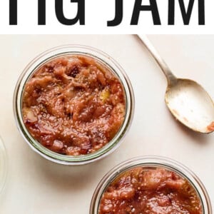 Two jars with homemade jam next to a spoon.