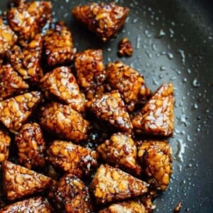 Maple balsamic tempeh cubes in a skillet.