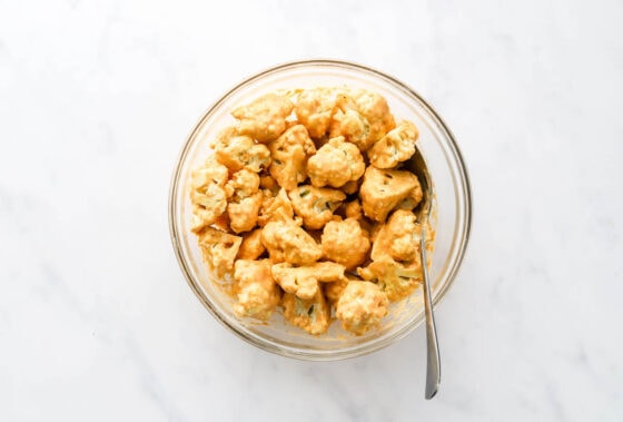 Cauliflower tossed in the seasoned flour mixture.