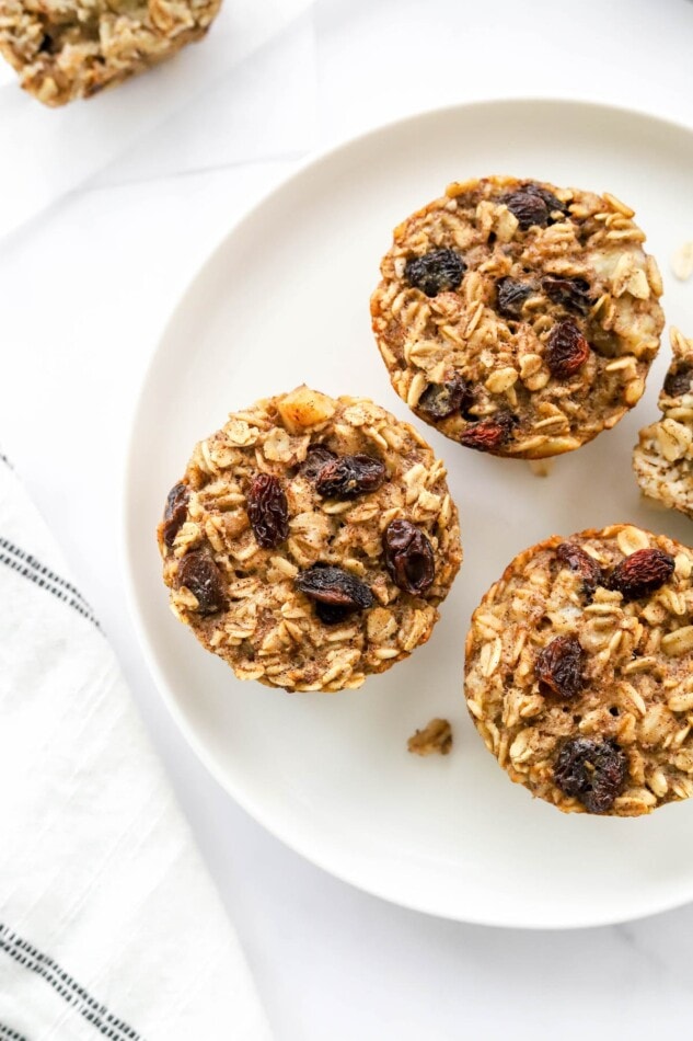 Overhead photo looking down at a plate with 3 banana baked oatmeal cups.