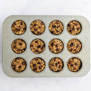 Banana baked oatmeal cups in a muffin tin after baking.
