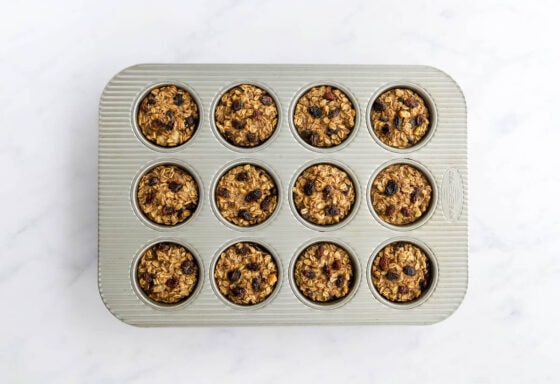 Banana baked oatmeal cups in a muffin tin after baking.