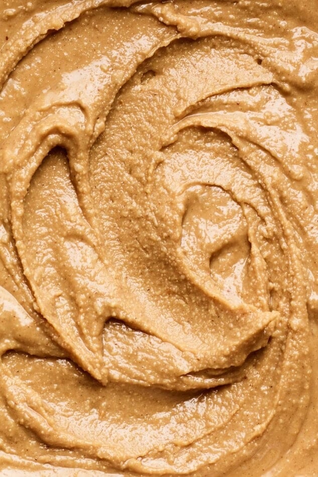 A close up photo of cinnamon peanut butter, exposing the creamy texture.