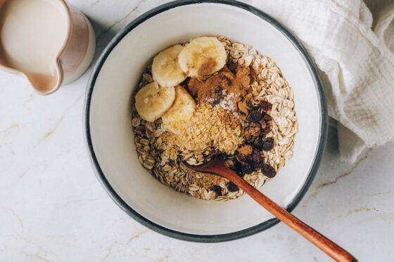 Oats, banana slices, raisins, flaxseed, cinnamon and sea salt in a pot.