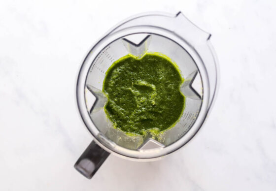 Romaine lettuce and spinach blended together in a blender.