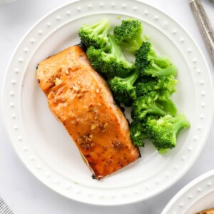 An overhead photo of a plate with a filet of maple glazed salmon. Steamed broccoli is also on the plate.