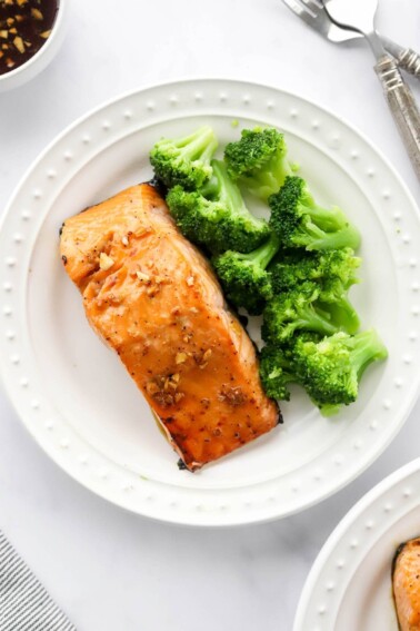 An overhead photo of a plate with a filet of maple glazed salmon. Steamed broccoli is also on the plate.