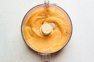 A food processor containing freshly pureed peaches.