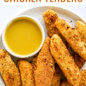 Plate of air fried chicken tenders with honey mustard dip.