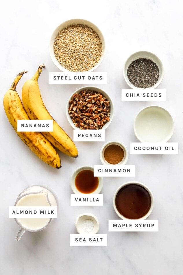 Ingredients measured out to make baked steel cut oatmeal: steel cut oats, chia seeds, pecans, bananas, coconut oil, cinnamon, vanilla, almond milk, sea salt and maple syrup.