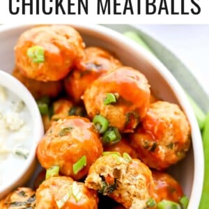 Bowl of buffalo chicken meatballs. One has a bite taken out of it.
