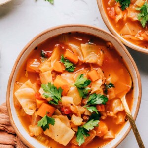 A birds eye view of a bowl of cabbage soup topped with fresh cilantro.