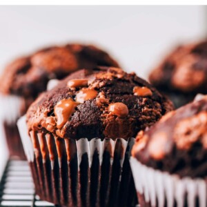 Close up of a chocolate chip muffin on a wire rack.