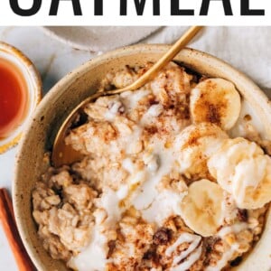 An overhead photo of a bowl of cinnamon raisin oatmeal topped with banana slices and a drizzle of coconut butter.