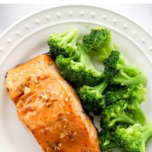 Plate with a filet of maple glazed salmon and steamed broccoli.