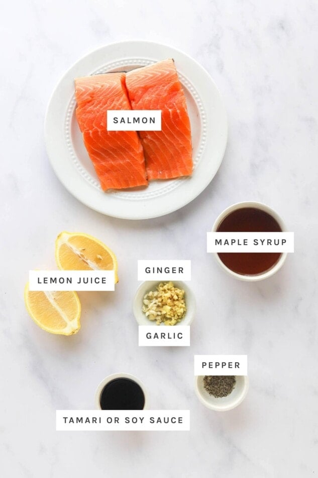 Ingredients measured out to make maple glazed salmon: salmon, maple syrup, lemon juice, ginger, garlic, pepper and tamari.