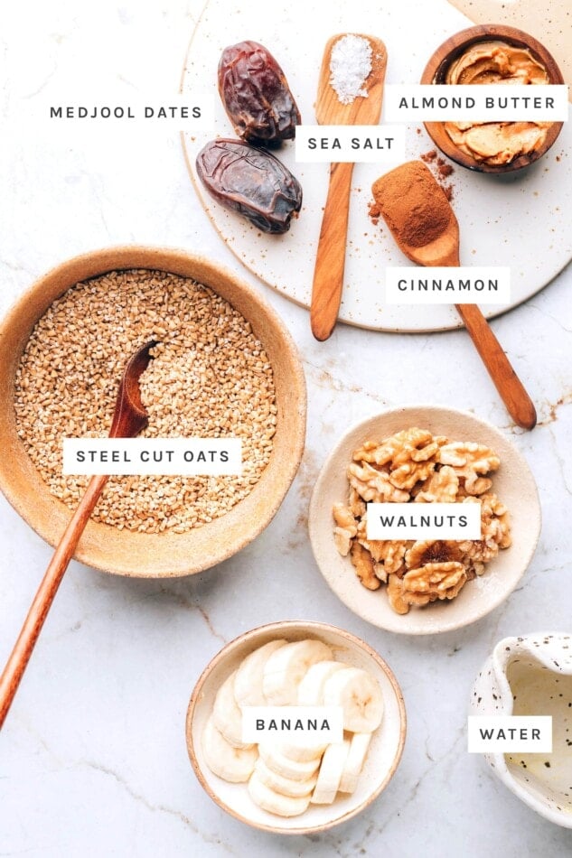 Ingredients measured out to make nutty date oatmeal: medjool dates, sea salt, almond butter, cinnamon, steel cut oats, walnuts, banana and water.