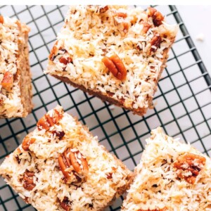 An overhead photo of 3 squares of oatmeal cake on a wire cooling rack.